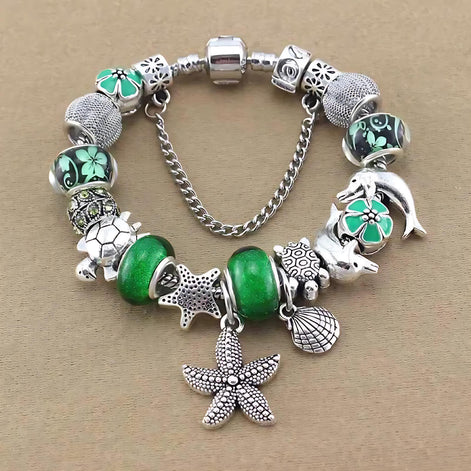Ocean Series Green Glass Bead Bracelet – Dolphin, Shell & Starfish Charms by Wave & Hang