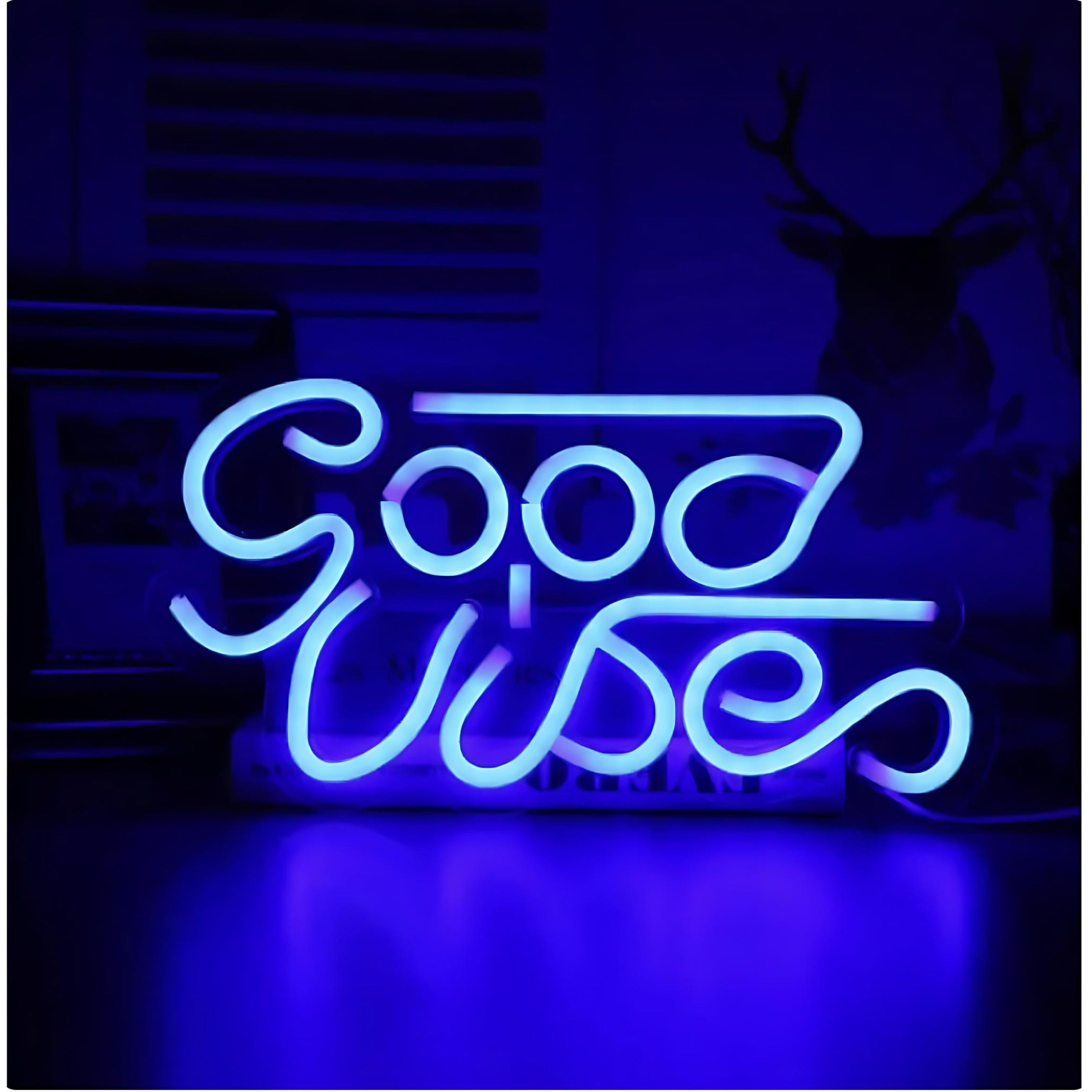 Blue neon sign that spells “Good Vibes” on dark background