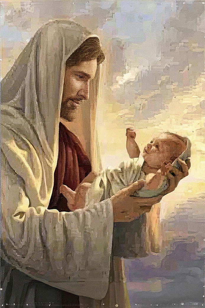 Close-up view of a diamond painting featuring Jesus gently holding a baby against a glowing sky background.