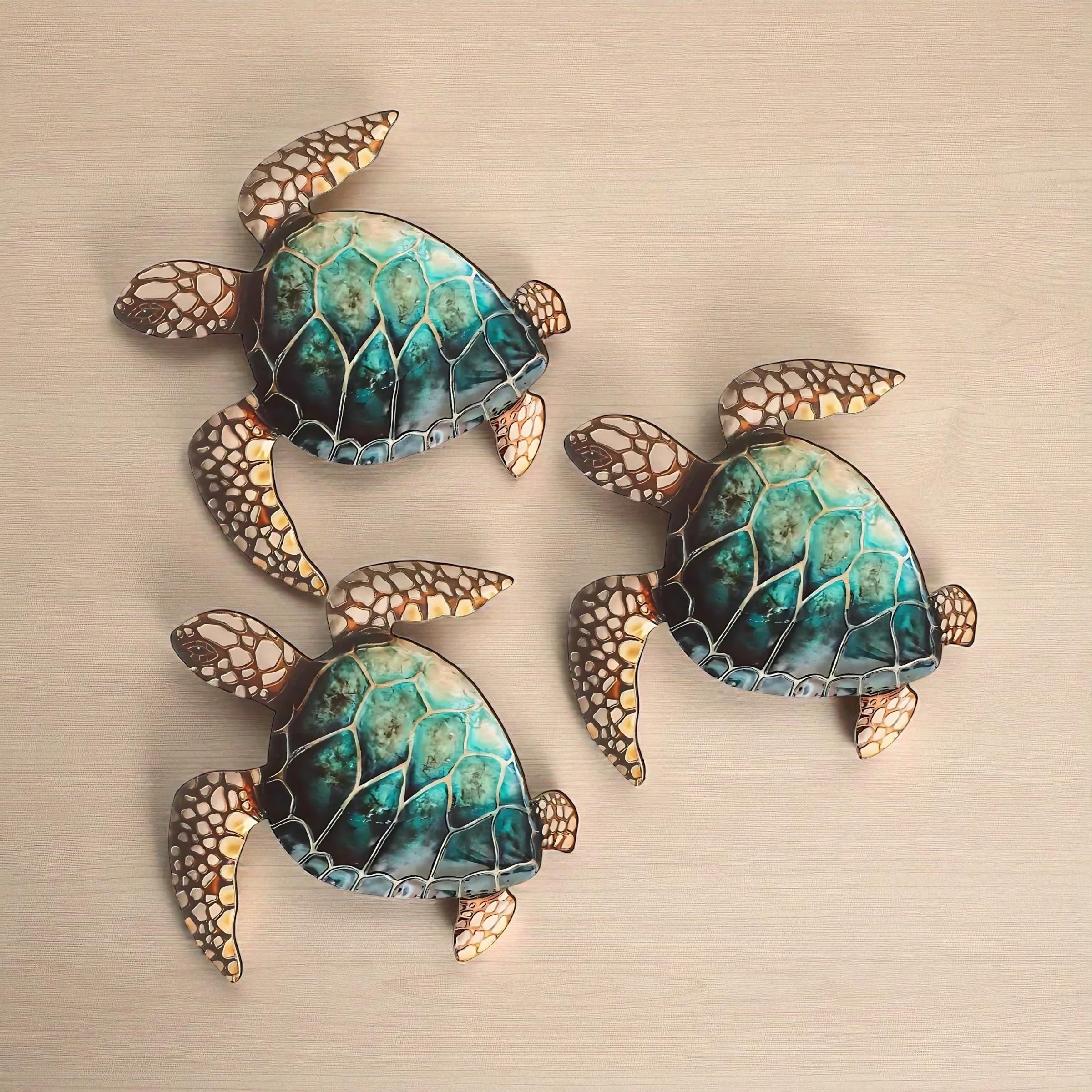 Three decorative sea turtle wall art pieces arranged on a beige surface