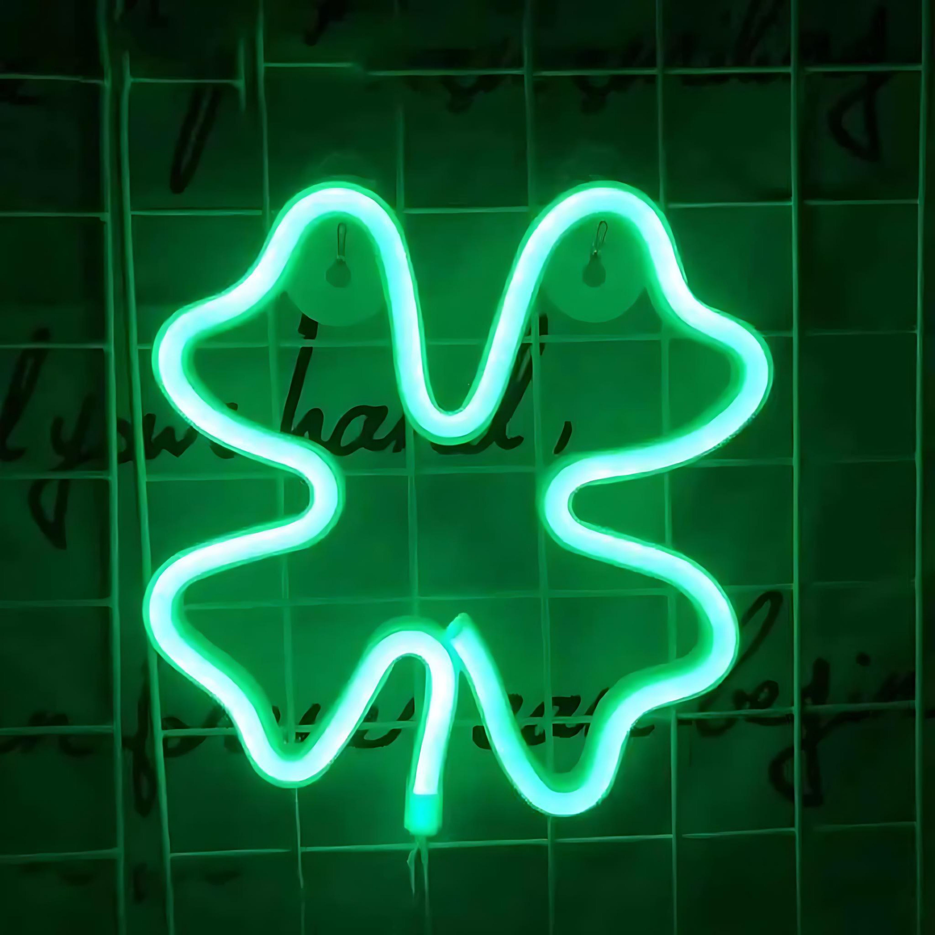 Green neon LED light shaped like a four leaf clover