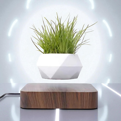 White geometric magnetic planter levitating with glowing LED background