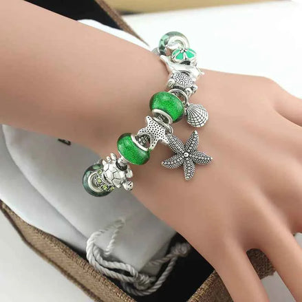 Ocean Series Green Glass Bead Bracelet – Dolphin, Shell & Starfish Charms