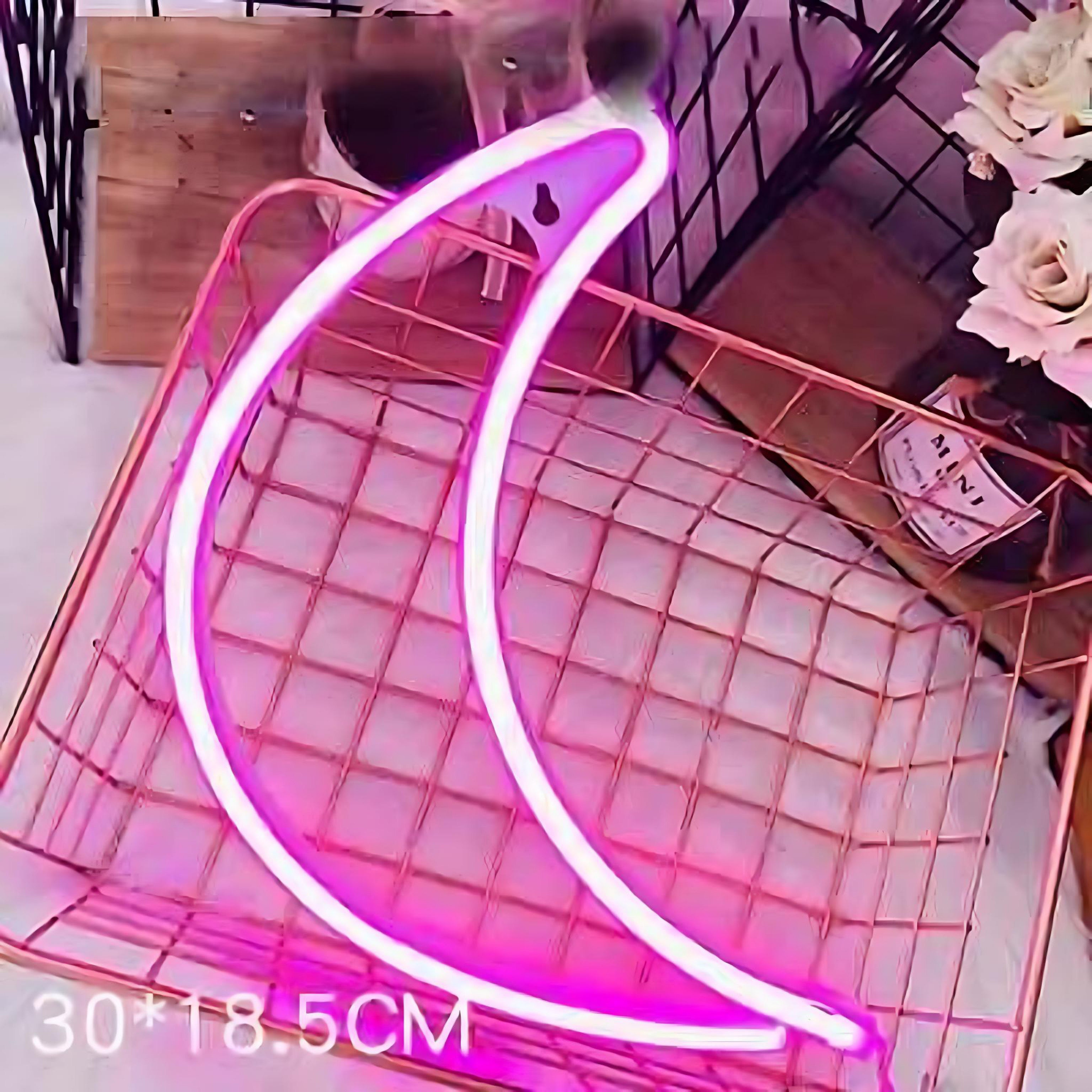 Pink neon crescent moon light on grid background