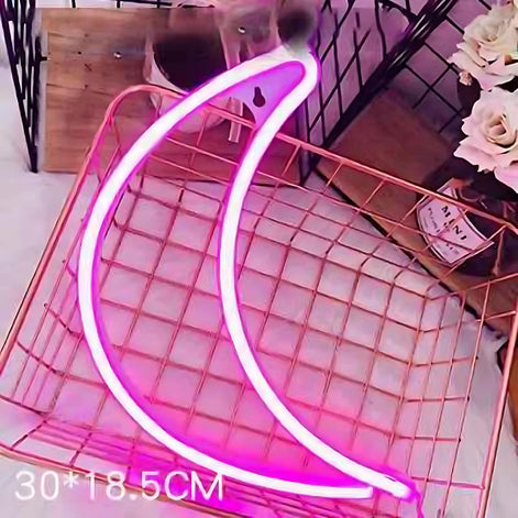 Pink neon crescent moon light on grid background