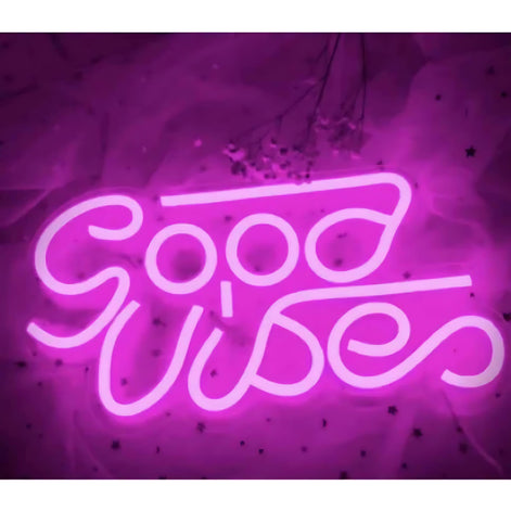 Pink neon sign spelling “Good Vibes” with glowing effect