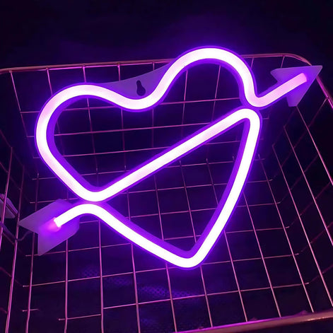 Pink neon light shaped like a heart with an arrow