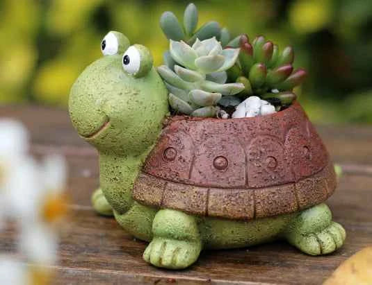 Green turtle-shaped succulent planter with assorted succulents, resin decorative pot