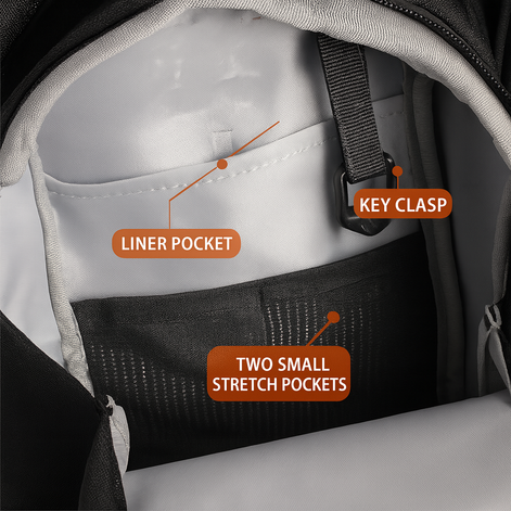 Close-up of the fitness bag interior showing a liner pocket, key clasp, and two small stretch pockets.