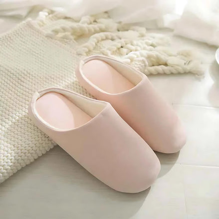 Soft cotton-linen pink indoor slippers placed on a cozy rug near sunlight.
