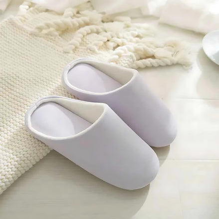 Soft cotton-linen light purple indoor slippers positioned on a bright floor.