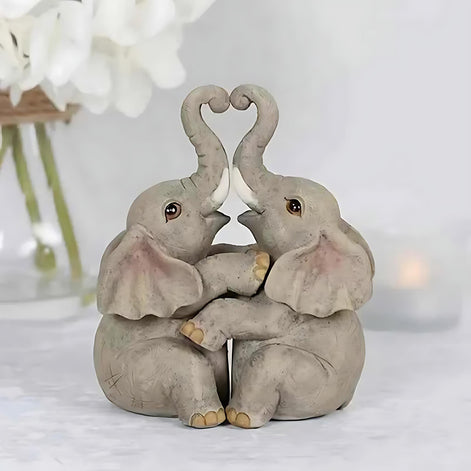Romantic resin elephant couple figurine with trunks forming a heart, perfect for Valentine’s Day home decor.
