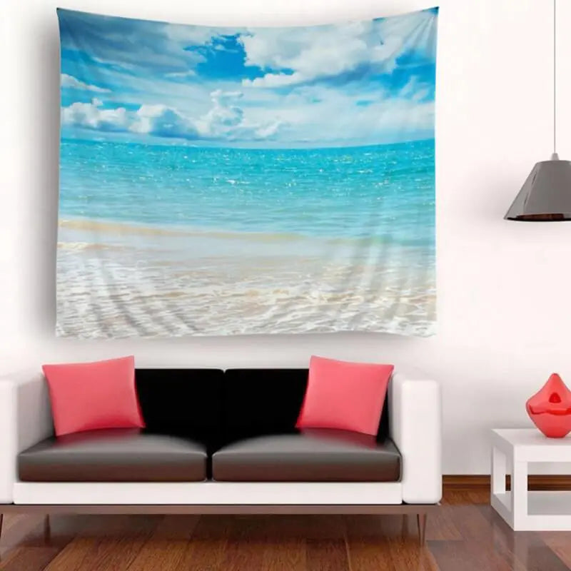 Hawaiian beach tapestry with ocean and sky print hanging on wall above modern black and white sofa with pink accent pillows and contemporary decor